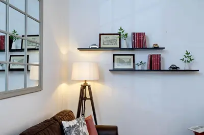 a room with a chair and a lamp on a wall at Bollo in Rome