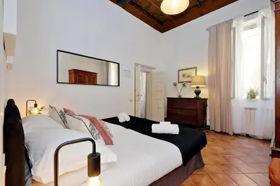 a bedroom with a bed and a mirror on the wall at Bollo in Rome