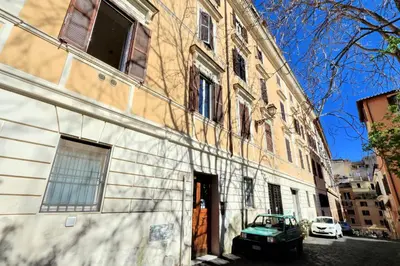a building with a green car parked in front of it at Clementina in Rome