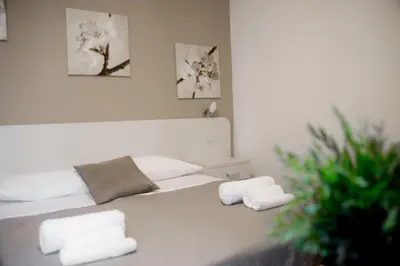a bedroom with a bed with towels on it at Anna Guest House in Rome