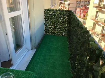 a green garden on a balcony with a window at Anna Guest House in Rome