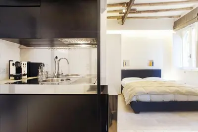 a kitchen with a sink and a bed in a room at Oro in Rome