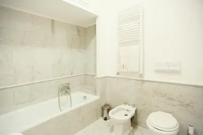 a bathroom with a tub and a toilet and a sink at S.Andrea in Rome
