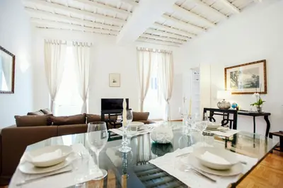 a living room with a glass table and a couch at S.Andrea in Rome