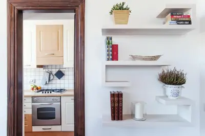 a kitchen with white shelves and a sink at Lungaretta3 in Rome
