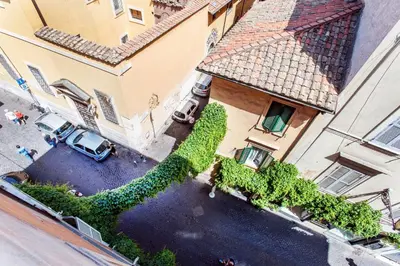 an overhead view of a building with cars parked in a courtyard at Lungaretta3 in Rome