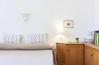 a bedroom with a bed and a wooden dresser at Otranto in Rome