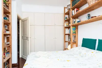 a bedroom with a bed and wooden shelves at Otranto in Rome