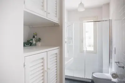 a white bathroom with a shower and a toilet at Otranto in Rome