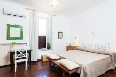 a bedroom with a bed and a table and a chair at Otranto in Rome