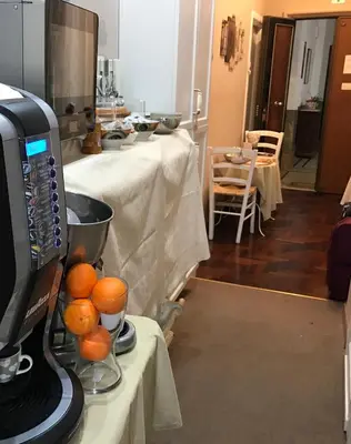 a kitchen with a juicer and oranges on a table at Morgagni House in Rome