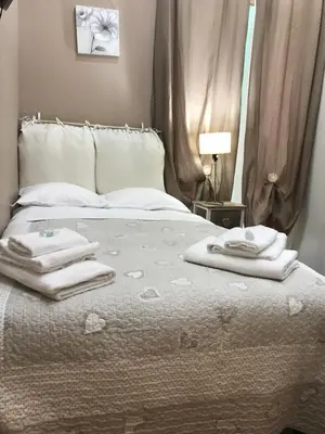 a bedroom with a bed with towels on it at Morgagni House in Rome