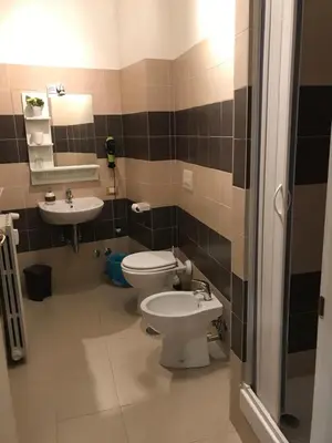 a bathroom with a toilet and a sink at Morgagni House in Rome