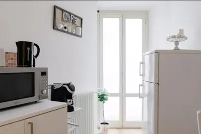 a kitchen with a microwave and a refrigerator at Charming 25 Apartment in Rome