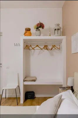 a bedroom with a bed and a white wall at Charming 25 Apartment in Rome