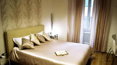 a bedroom with a bed with a book on it at Charming 25 Apartment in Rome