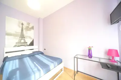 a bedroom with a bed and a picture of the eiffel tower at La Quiete in Rome