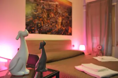 two cats sitting on a table in a living room at La Quiete in Rome