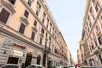 a row of buildings on a city street with cars at A Roman Tale B&B in Rome