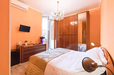 a bedroom with a bed and a dresser and a chandelier at A Roman Tale B&B in Rome