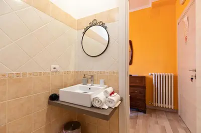 a bathroom with a sink and a mirror at A Roman Tale B&B in Rome