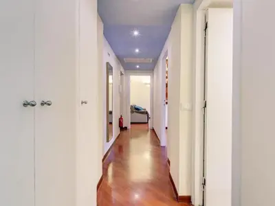 a hallway with white walls and a hard wood floor at Folia Domus in Rome