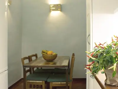 a table and chairs with a bowl of fruit on it at Folia Domus in Rome