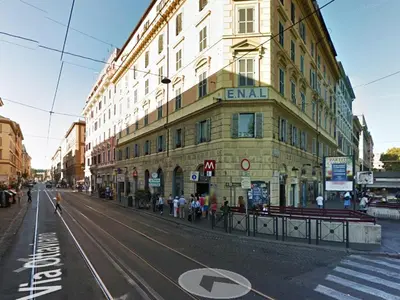 an empty street in a city with a building at Folia Domus in Rome