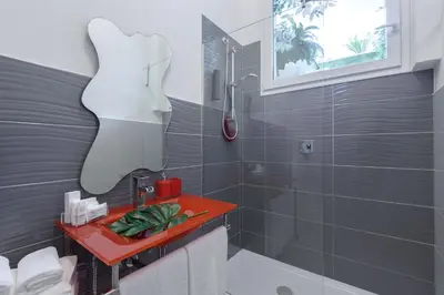 a bathroom with a red sink and a shower at Tama Rooms in Rome