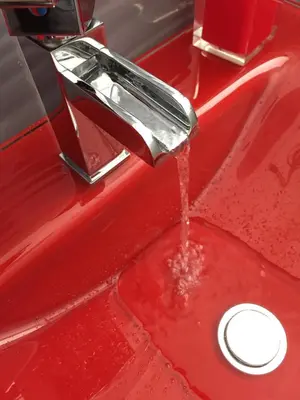 a red sink with water running from a faucet at Tama Rooms in Rome