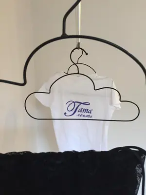 a white shirt is hanging on a hanger at Tama Rooms in Rome