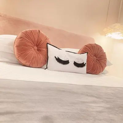 a bed with two pillows with lashes on it at Tama Rooms in Rome
