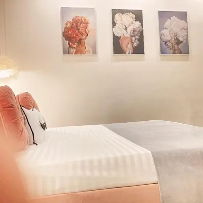 a bedroom with three pictures on the wall and a bed at Tama Rooms in Rome