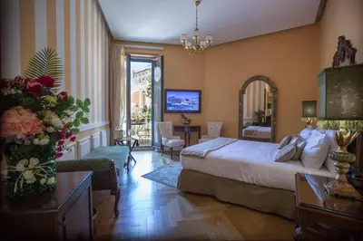 a bedroom with a bed and a living room at Royal Suite Trinità Dei Monti in Rome