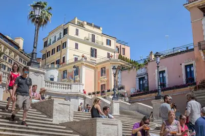 a group of people sitting on the steps of a building at Royal Suite Trinità Dei Monti in Rome