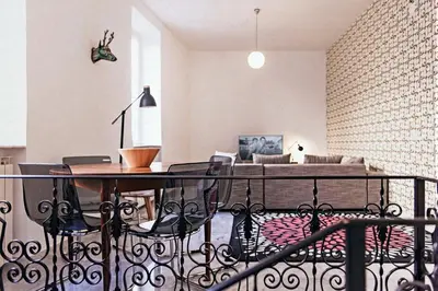 a balcony with a table and chairs in a living room at TrastevereHome - Sales Rome in Rome