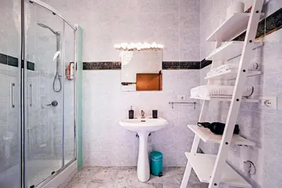 a white bathroom with a sink and a shower at TrastevereHome - Sales Rome in Rome
