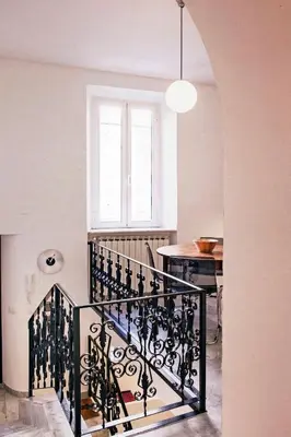 a staircase in a room with a window and a table at TrastevereHome - Sales Rome in Rome