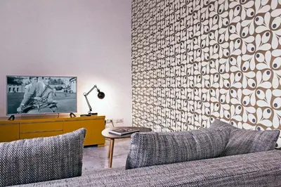 a living room with a couch and a wall at TrastevereHome - Sales Rome in Rome