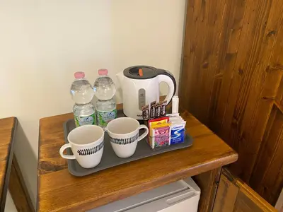a tray with cups and water bottles on a table at Guest House Laocoonte in Rome