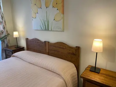 a bedroom with a bed and two lamps and a painting at Guest House Laocoonte in Rome