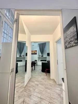 a hallway with a living room and a dining room at Appartamento Il Tempio Della Capitale in Rome