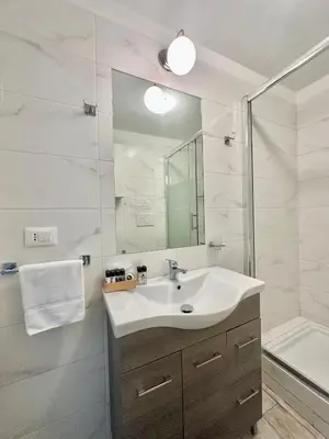 a bathroom with a sink and a shower at Appartamento Il Tempio Della Capitale in Rome