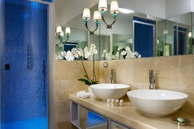 a bathroom with two sinks and a large mirror at Lifestyle Suites Rome in Rome