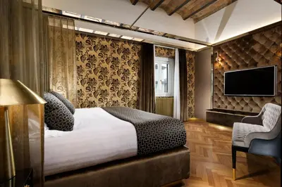 a hotel room with a bed and a television at Lifestyle Suites Rome in Rome