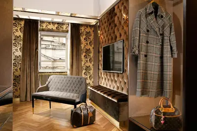 a room with a chair and a coat on a wall at Lifestyle Suites Rome in Rome