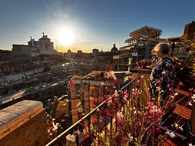 a man standing on a balcony overlooking a city at Residenza Maritti ContemporarySuite - Guesthouse in Rome