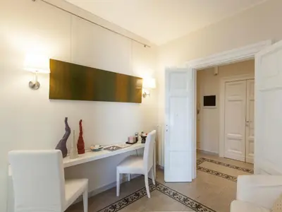 a room with a desk and two white chairs at Residenza Maritti ContemporarySuite - Guesthouse in Rome