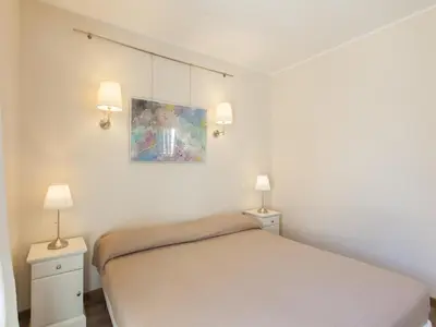a white bedroom with a bed and two lamps at Residenza Maritti ContemporarySuite - Guesthouse in Rome