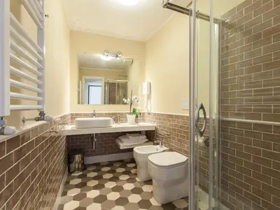 a bathroom with a toilet and a sink and a mirror at Residenza Maritti ContemporarySuite - Guesthouse in Rome